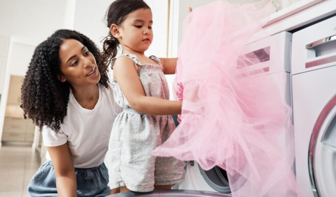 Mom and child learning to use the washing machine.